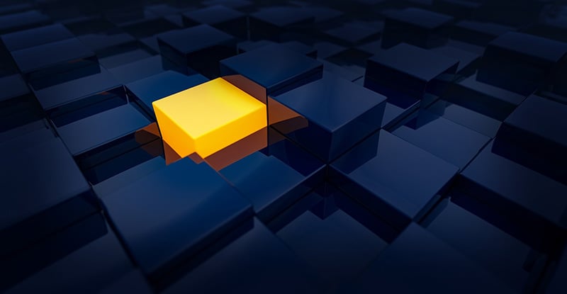 Ask Learner Support: Selecting a CFE Role A photo of a dark room filled with blue cubes, with a fully lit yellow cube prominently glowing in the center.
