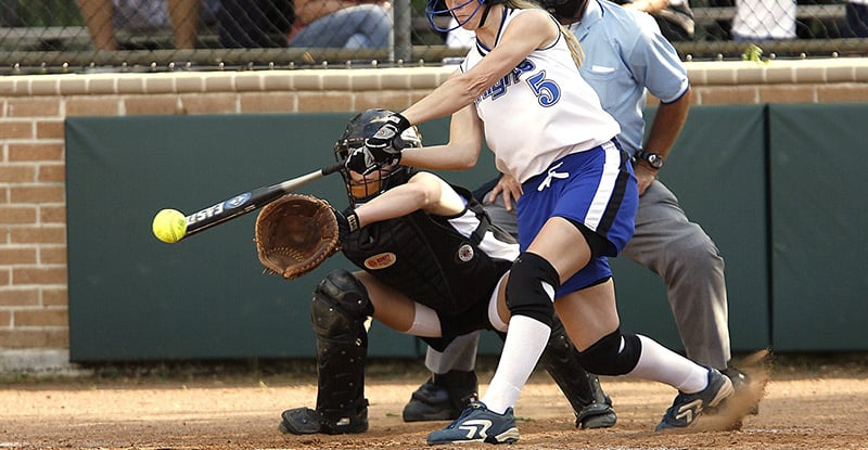 Swing and a hit: Knock-out your Capstone 1 Virtual Presentation A photo of a woman hitting a ball with a baseball bat at a tournament.