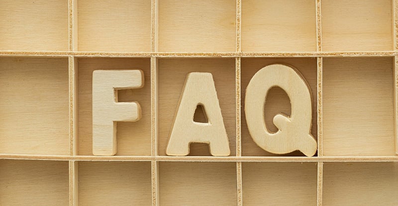 Capstone 2: FAQs and resources explained A photo of a wooden shelf with the letters 'FAQ,' also made from wood, fitted into the shelves.