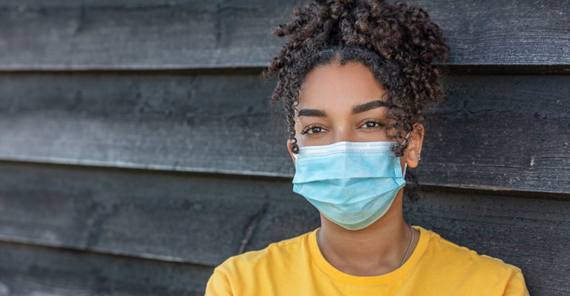 Update on CPA Preparatory Course Assessments: Delivery and Schedule 2021 A photo of an African descent woman wearing a face mask and looking directly at the camera.