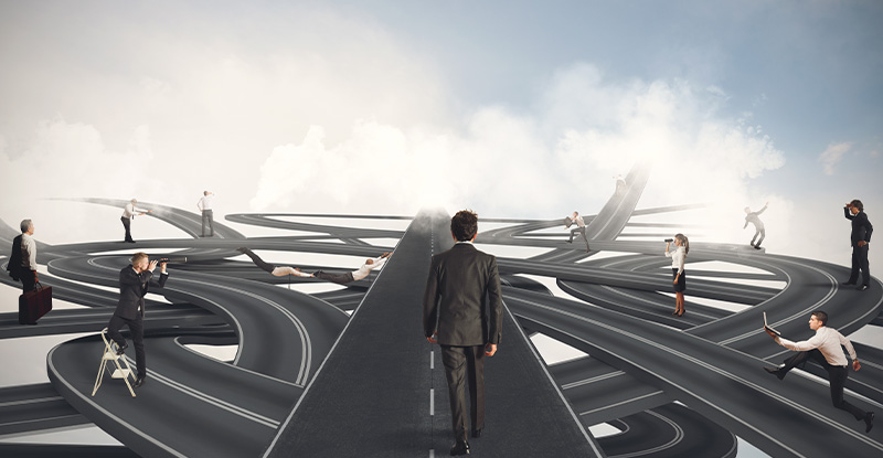 An illustration of different indirect roads with people trying to find the path and there is a man in the centre with a straight indicating he has found the path to his destination.