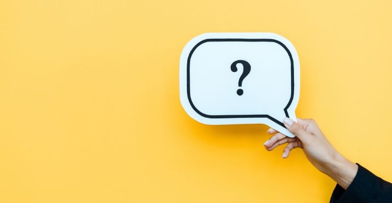 When will my CPAWSB course grade show up on my transcript assessment? An illustration against a blue background featuring a person holding a question mark card.