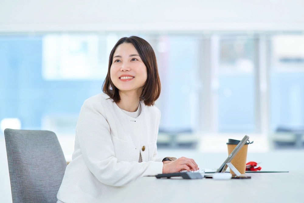 a woman sitting at a desk with a computer