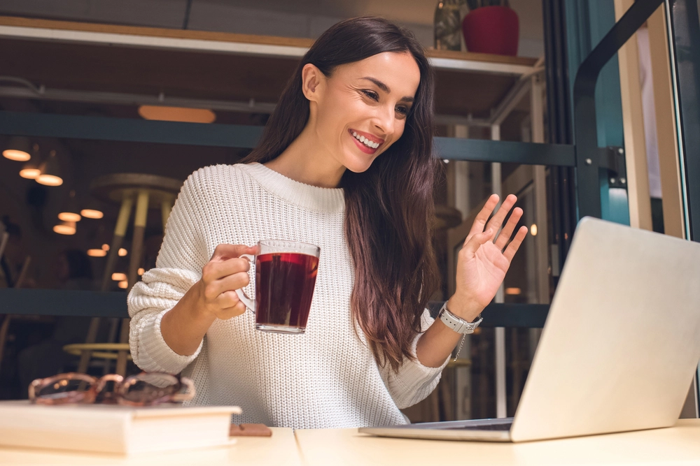 a woman holding a cup of tea