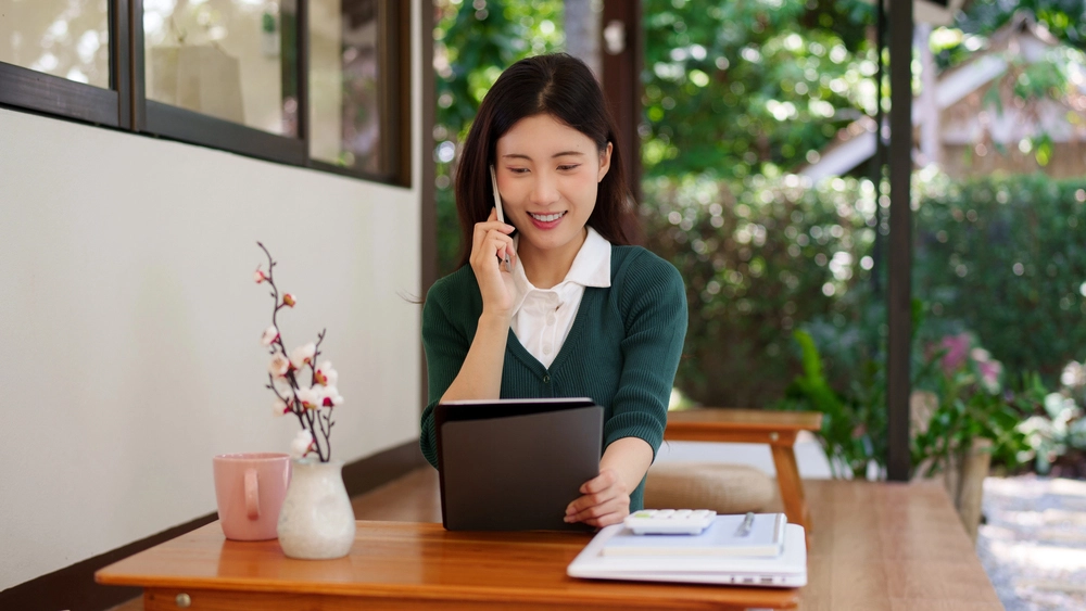 a woman holding a tablet and talking on the phone