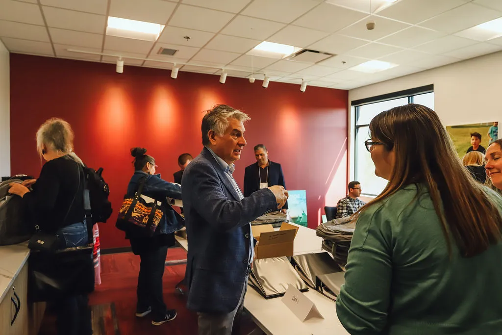 a man and woman standing in a room with people