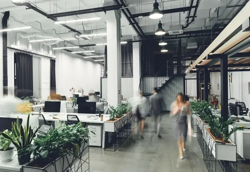 a group of people walking in an office