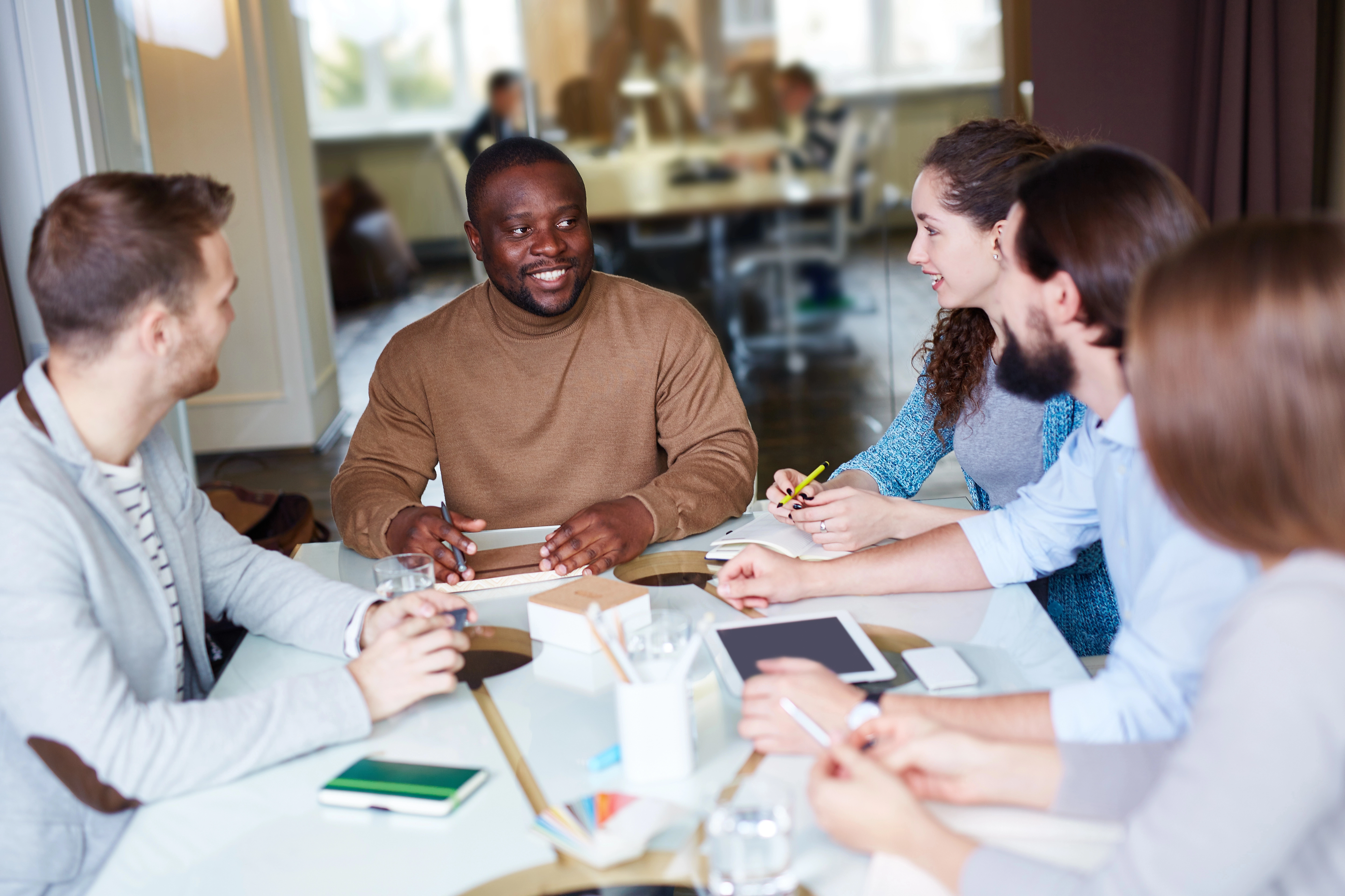a group of people sitting around a table