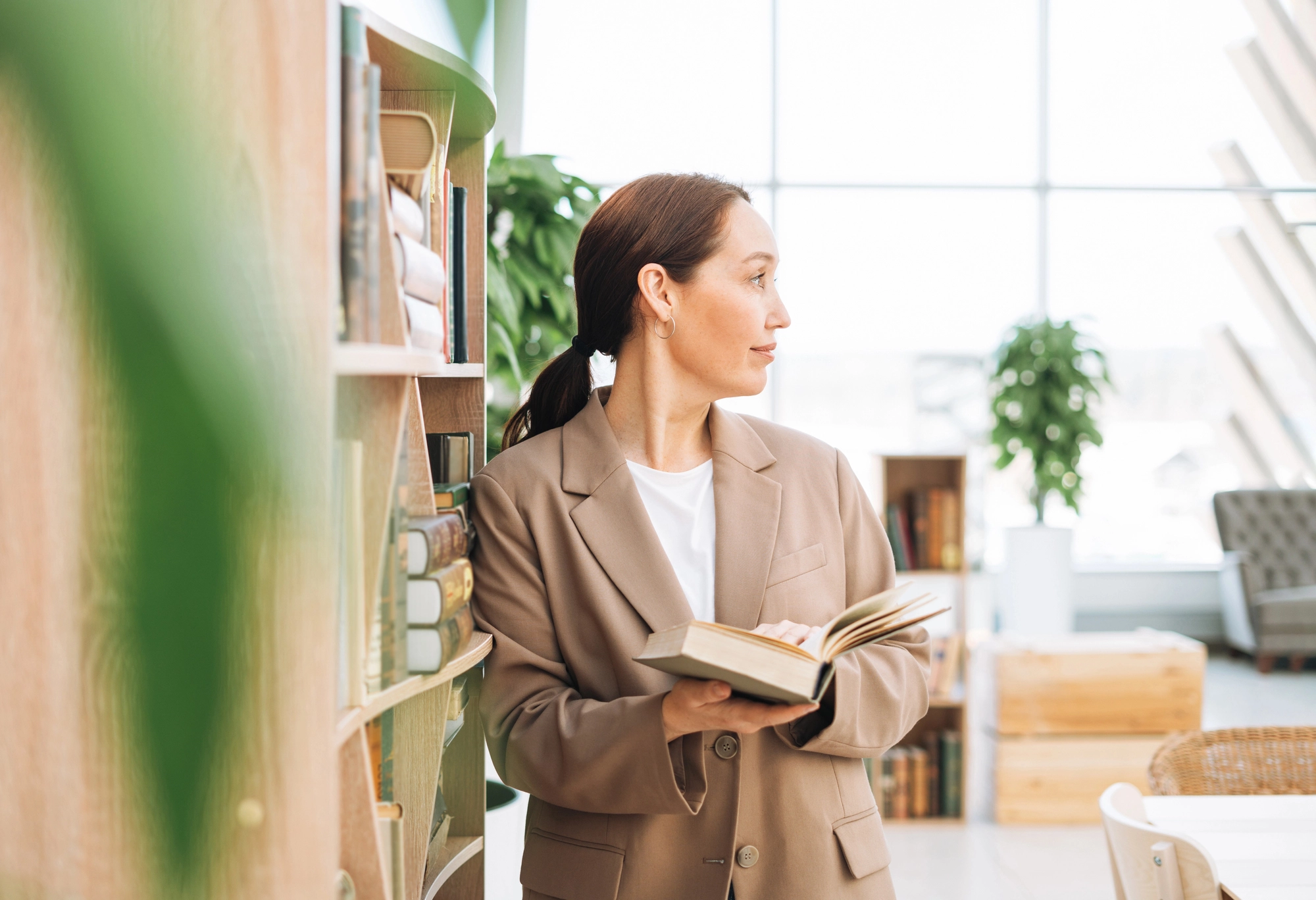 a woman in a suit holding a book
