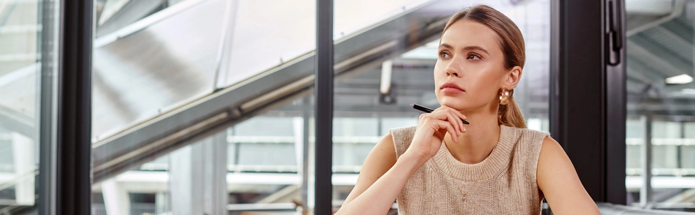 a woman holding her chin and looking away