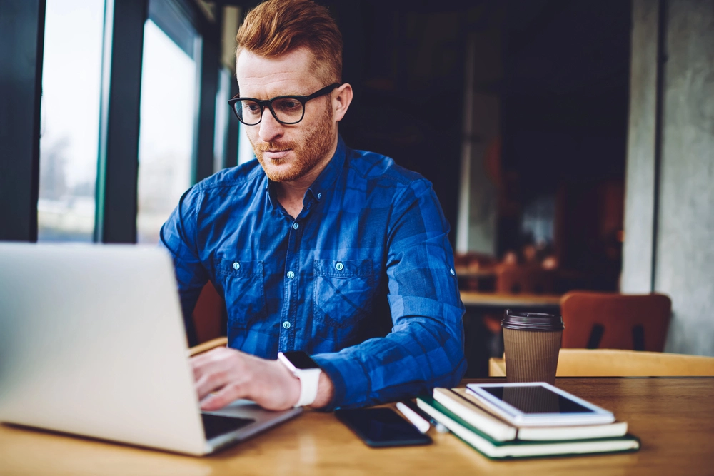a man sitting at a table with a laptop