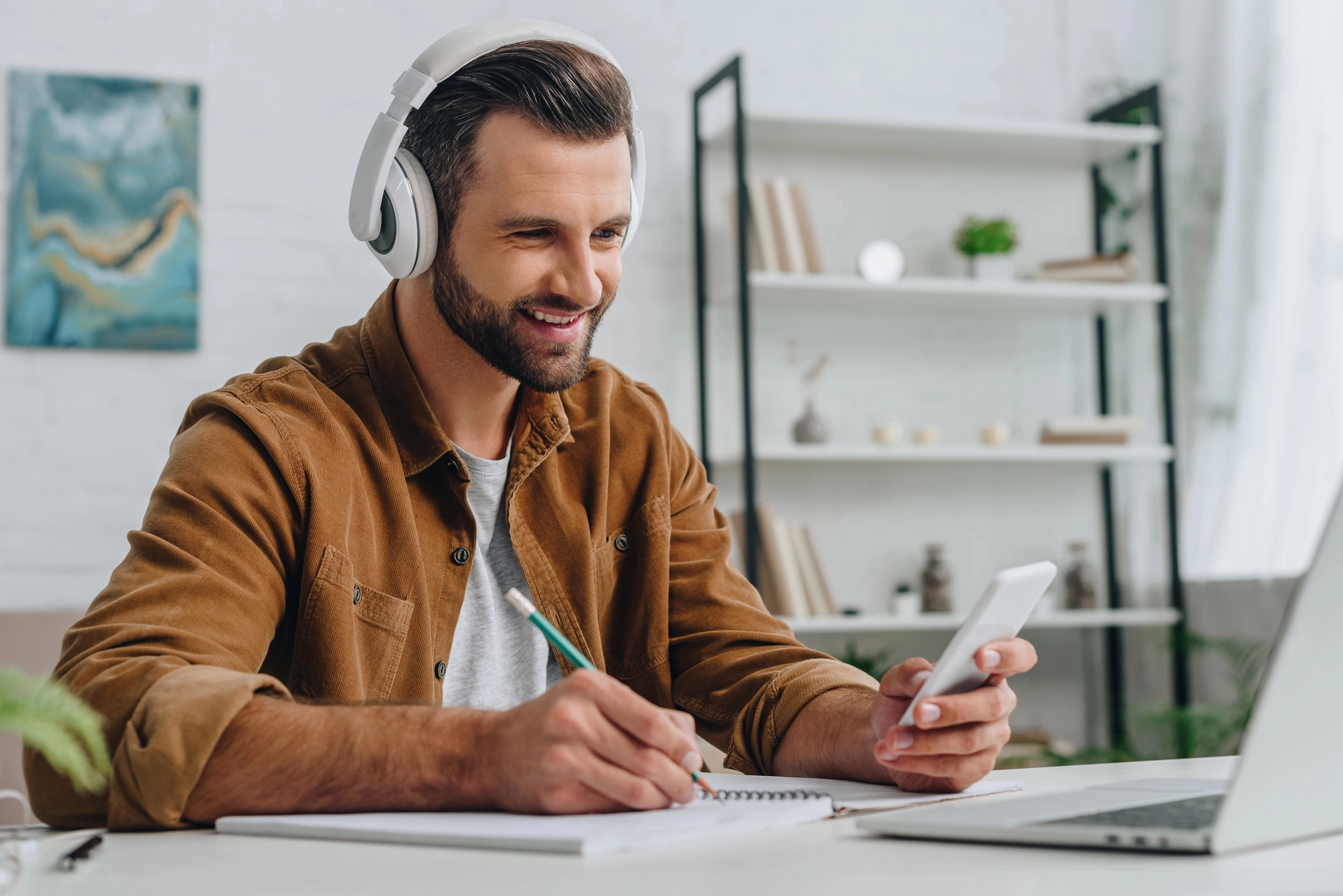 a man wearing headphones and using a phone