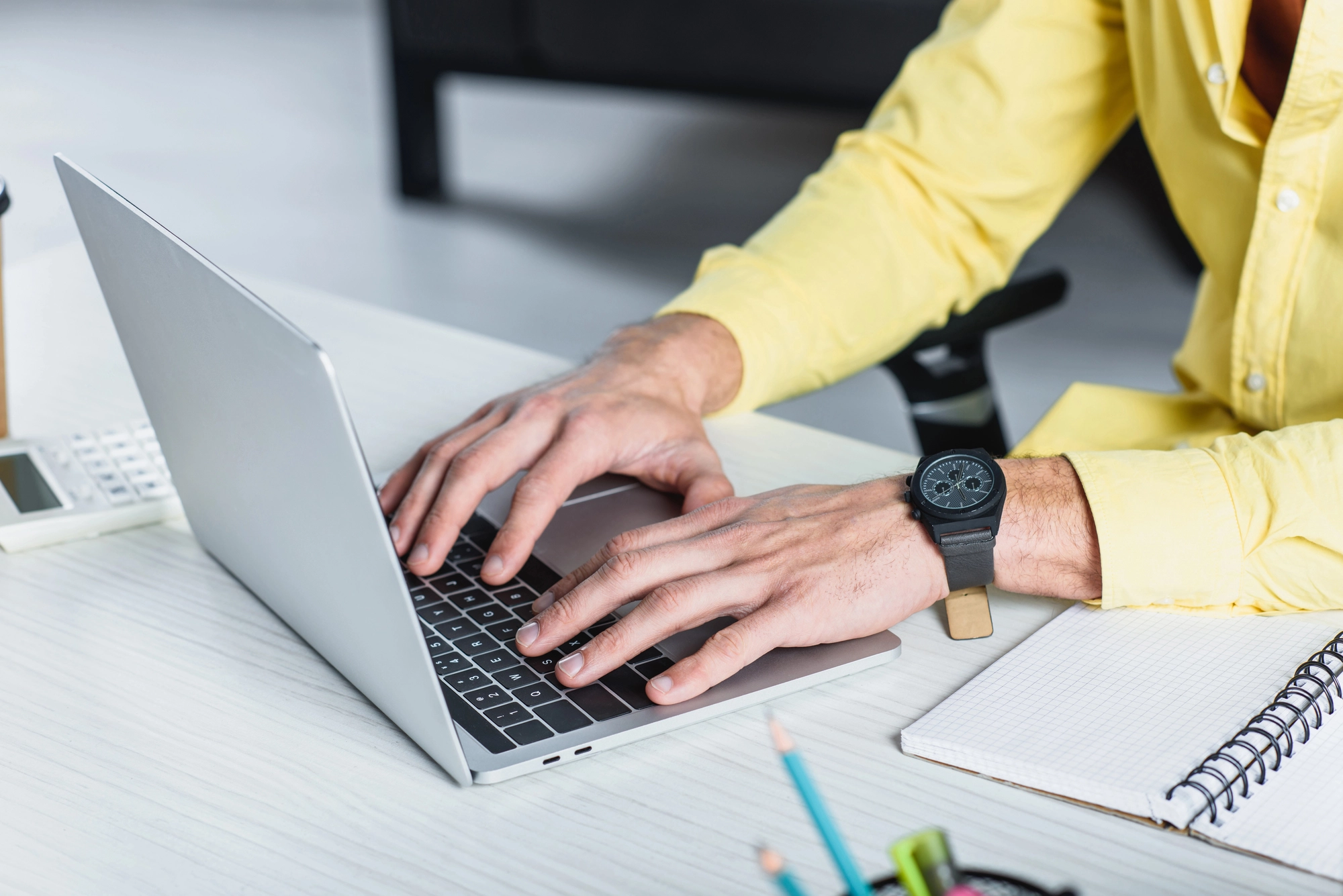 a person typing on a laptop