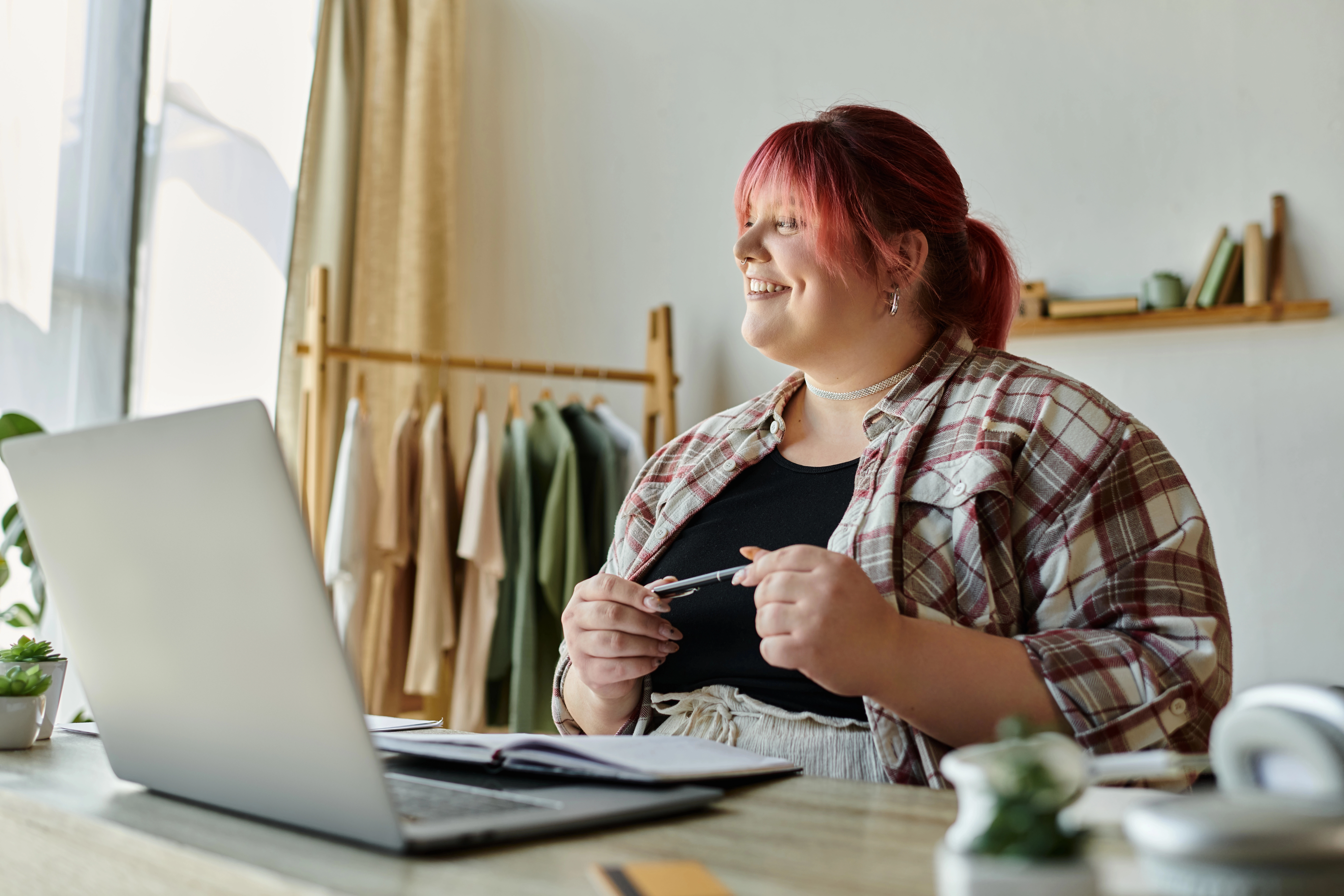 a woman smiling at a laptop