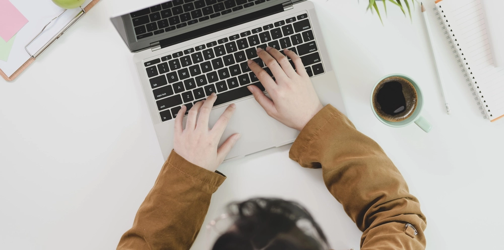 a person typing on a laptop