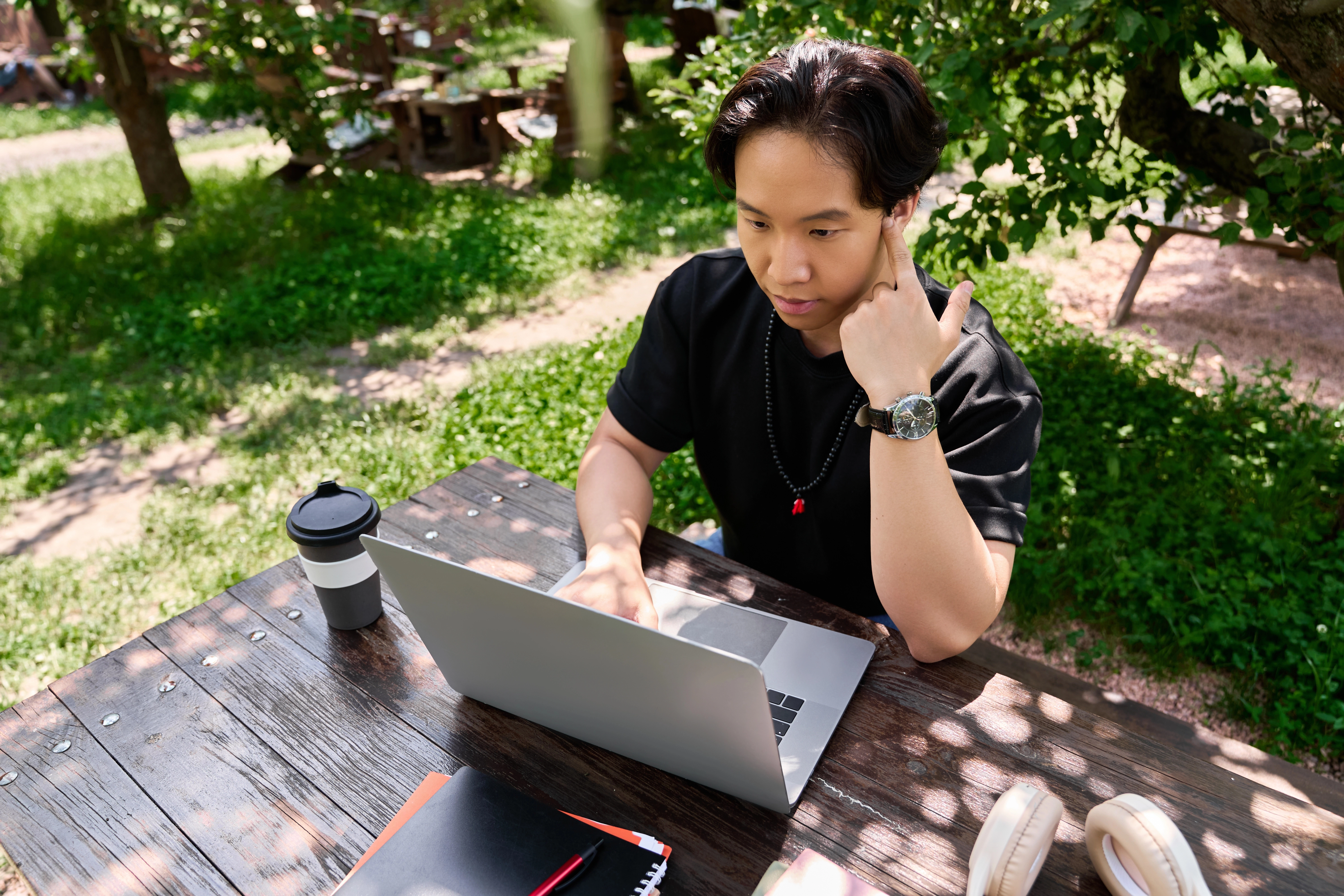 a man sitting at a table with a laptop