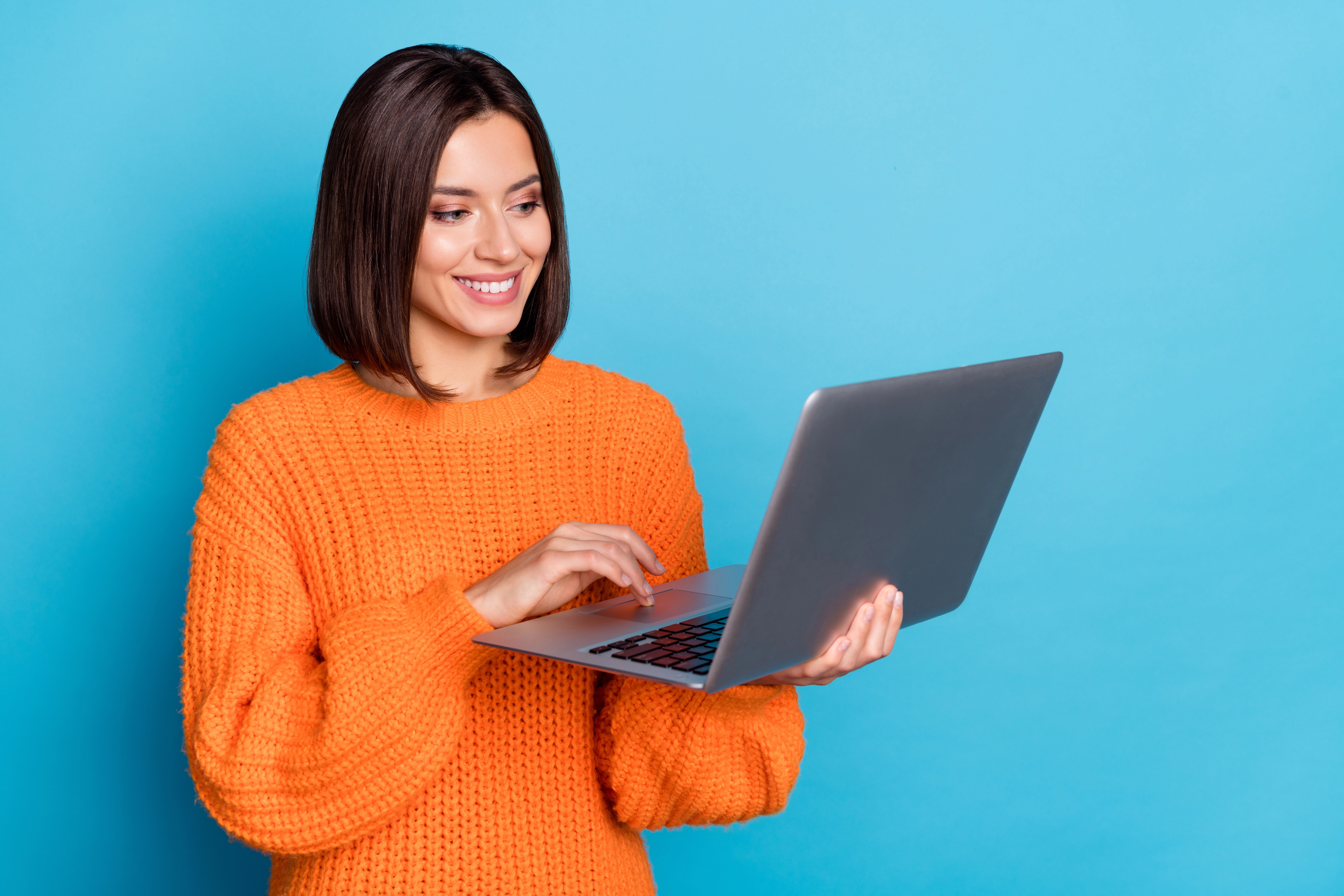 a woman holding a laptop