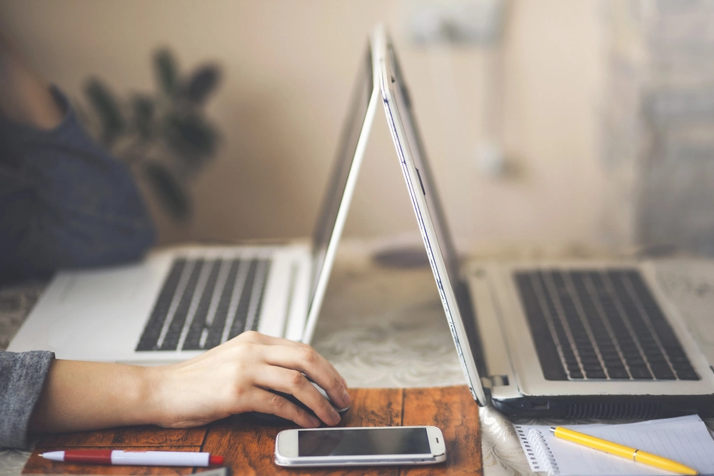 a hand on a laptop