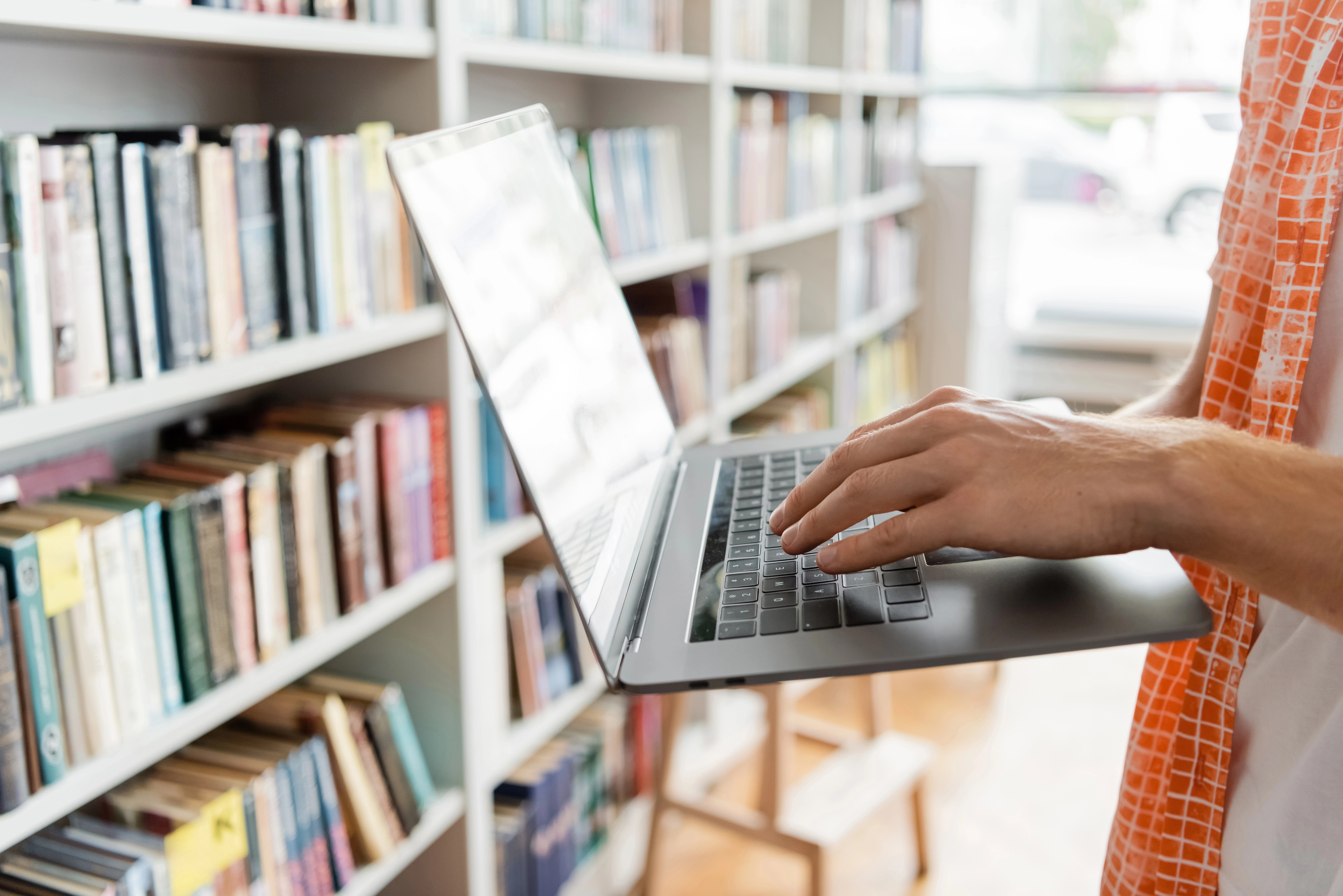 a person using a laptop in a library