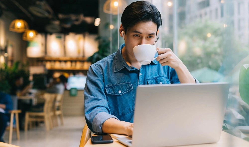 a man drinking from a cup