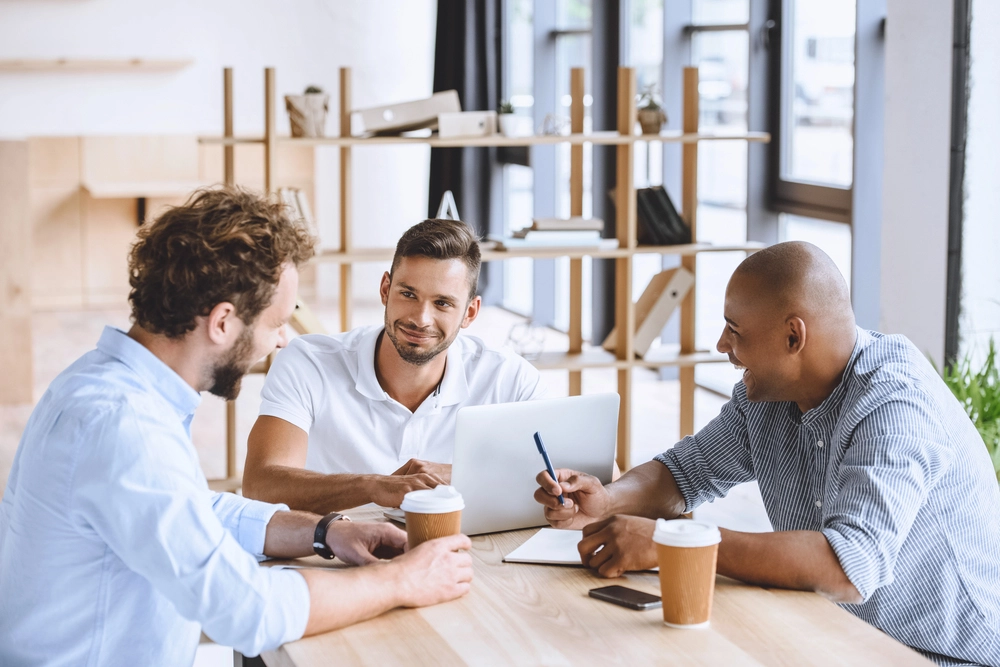 a group of men sitting at a table