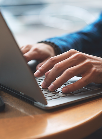 Personal Information Changes A photo focusing on a person’s hand typing on a laptop, with only the hand and keyboard visible to emphasize the action.