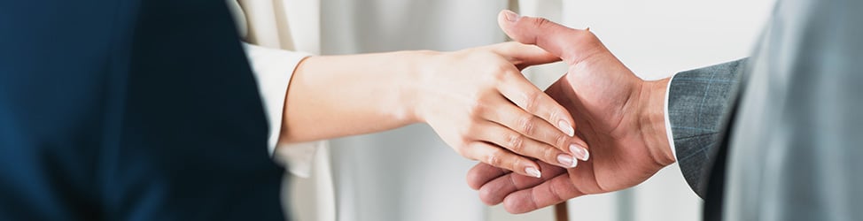 Mobile Banner A photo of two people shaking hands. Only the hands are visible.