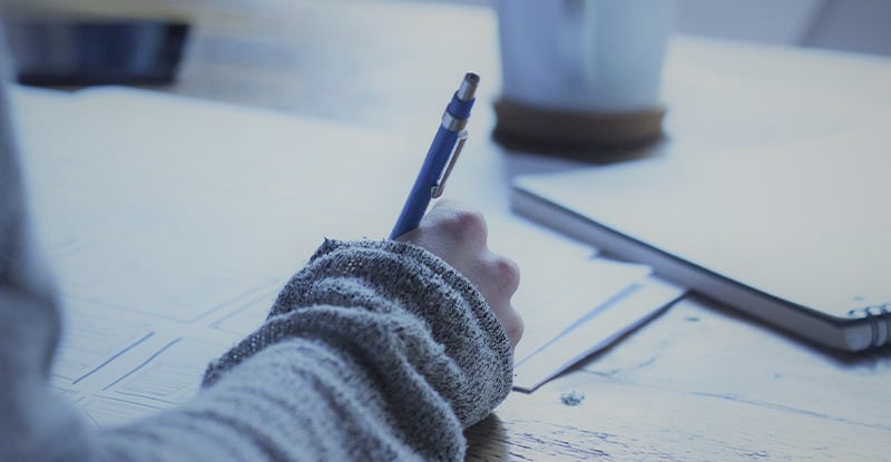 Tips for a Better Response: Case Writing A photo of a person writing on a notebook.