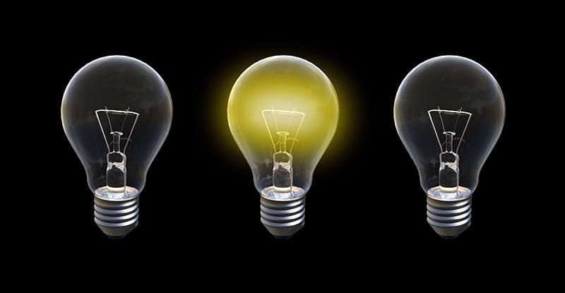 Power Move: Part 3 – The Professional A photo with a black background with three light bulbs placed beside each other and only the bulb in the centre is lit.