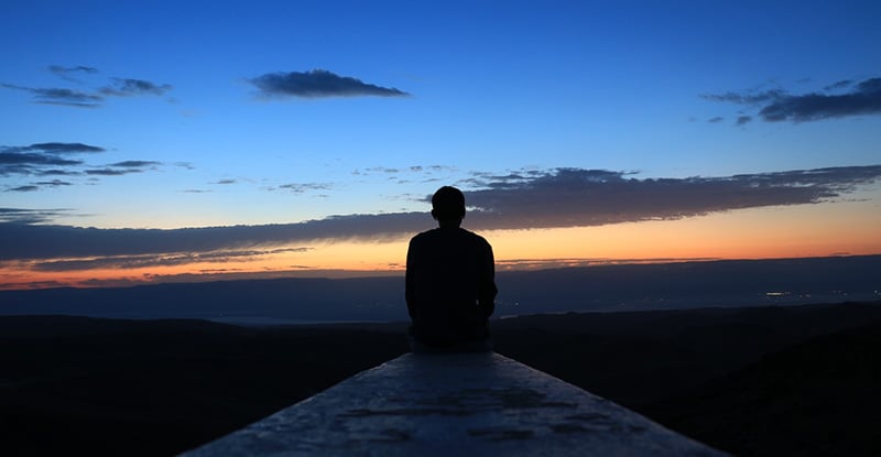 New Year New Utilization: Incorporating PEP module changes to your study plan A photo of a person sitting on a ledge watching the sunset.