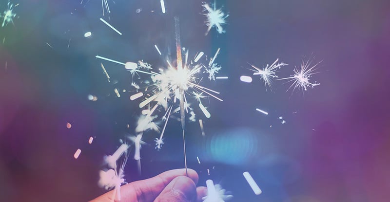 Meet Adam Zanoni, an award-winning facilitator A photo of a person holding a sparkler creating a whimsical look.