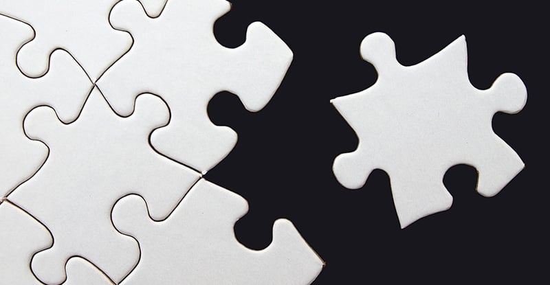 Submitting Tasks After Reaching 75% for Exam Eligibility A photo of white puzzle pieces on a black background with only one puzzle piece set aside.