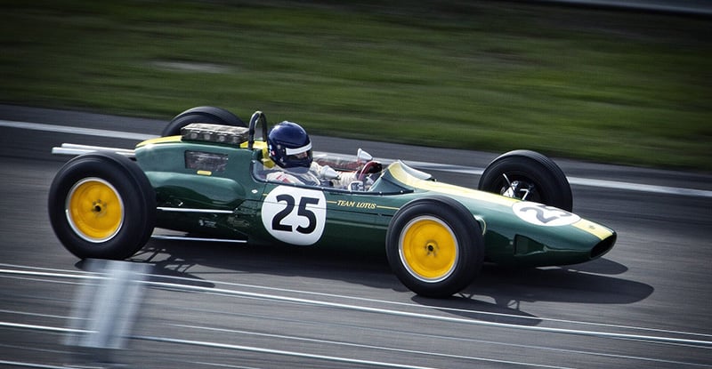 Module Fast Track: Is it for me? A photo of a person driving a dark green racing car with the number 25 on it.