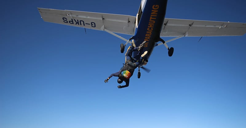 Career Progression, Part 1: The end, a new beginning A photo of a person diving out of a small plane.