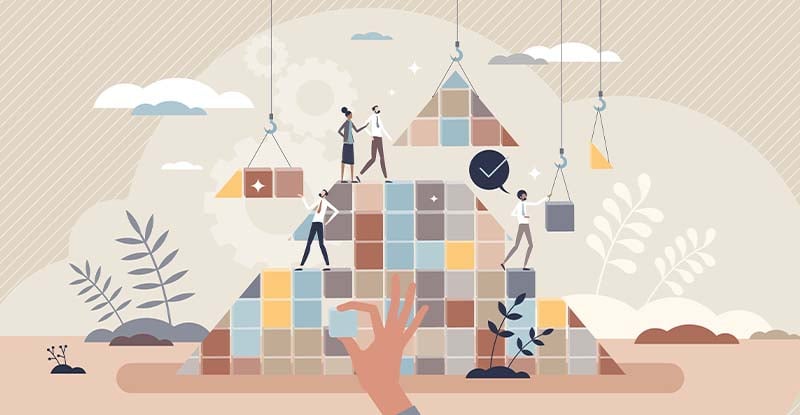 Effective Elective Planning: Part 1 An illustration showing small pyramids being constructed with squares and triangles arranged by a crane handle. Several people are overseeing the progress, symbolizing collaboration and precision.