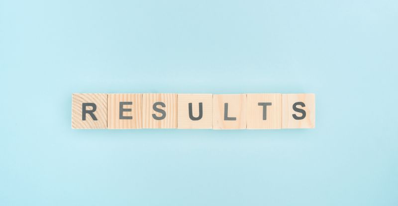 A photo featuring a light blue background with letter blocks that read "Results".