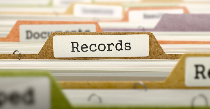 A photo of a filing cabinet focused on one file age named "Records".
