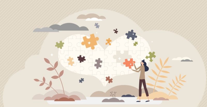 An illustration if a heart formed by puzzle pieces put together by a female character.