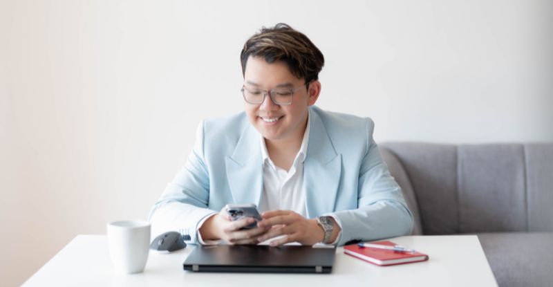 Photo of Calvin Loi, CPA on his phone. He is the 2022 Exemplary Award winner.